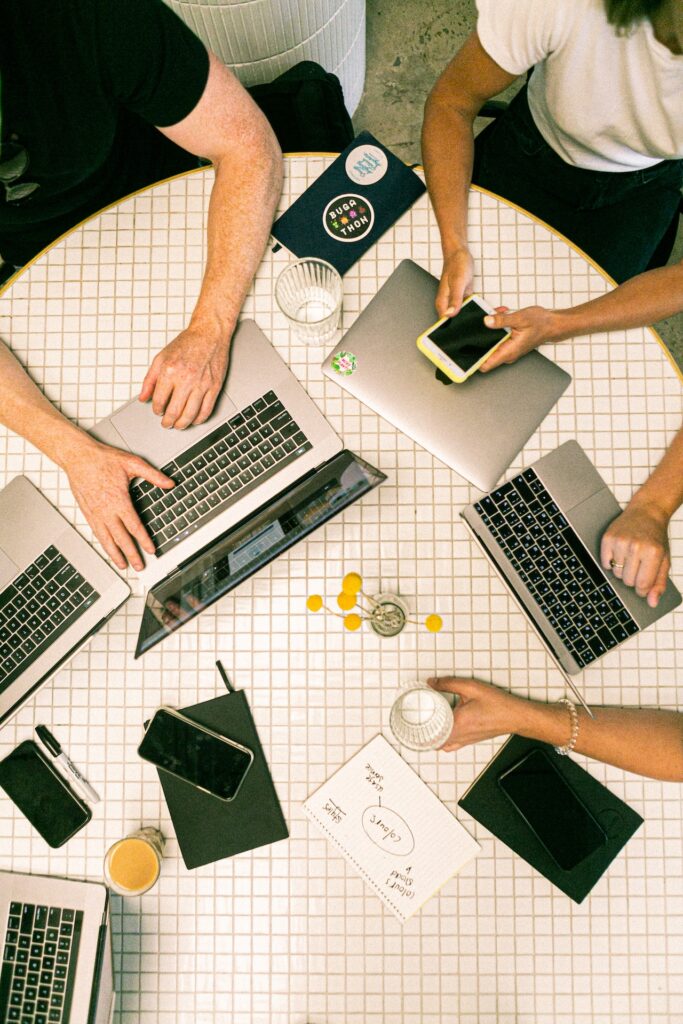 several people sitting on a table collaborating